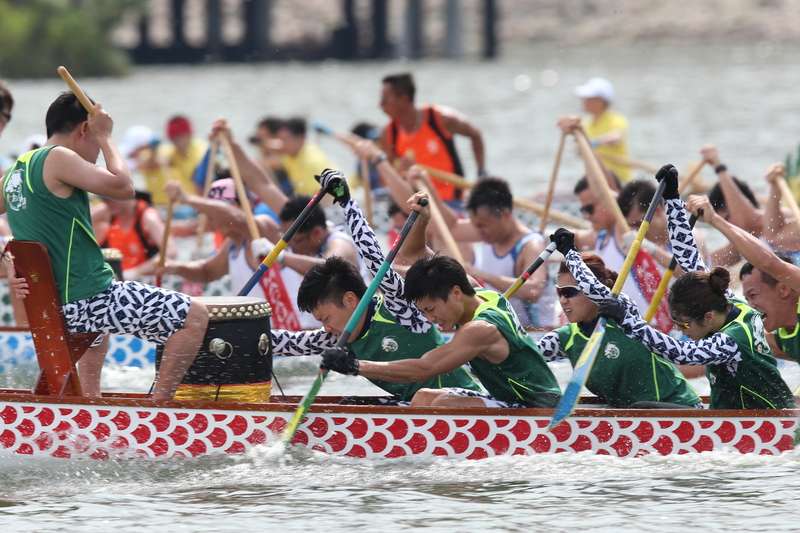 Team competing in dragon boat race. 