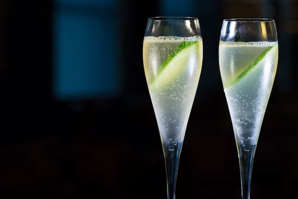 Two vodka-based cocktails in long stem glasses, displayed against a black background.