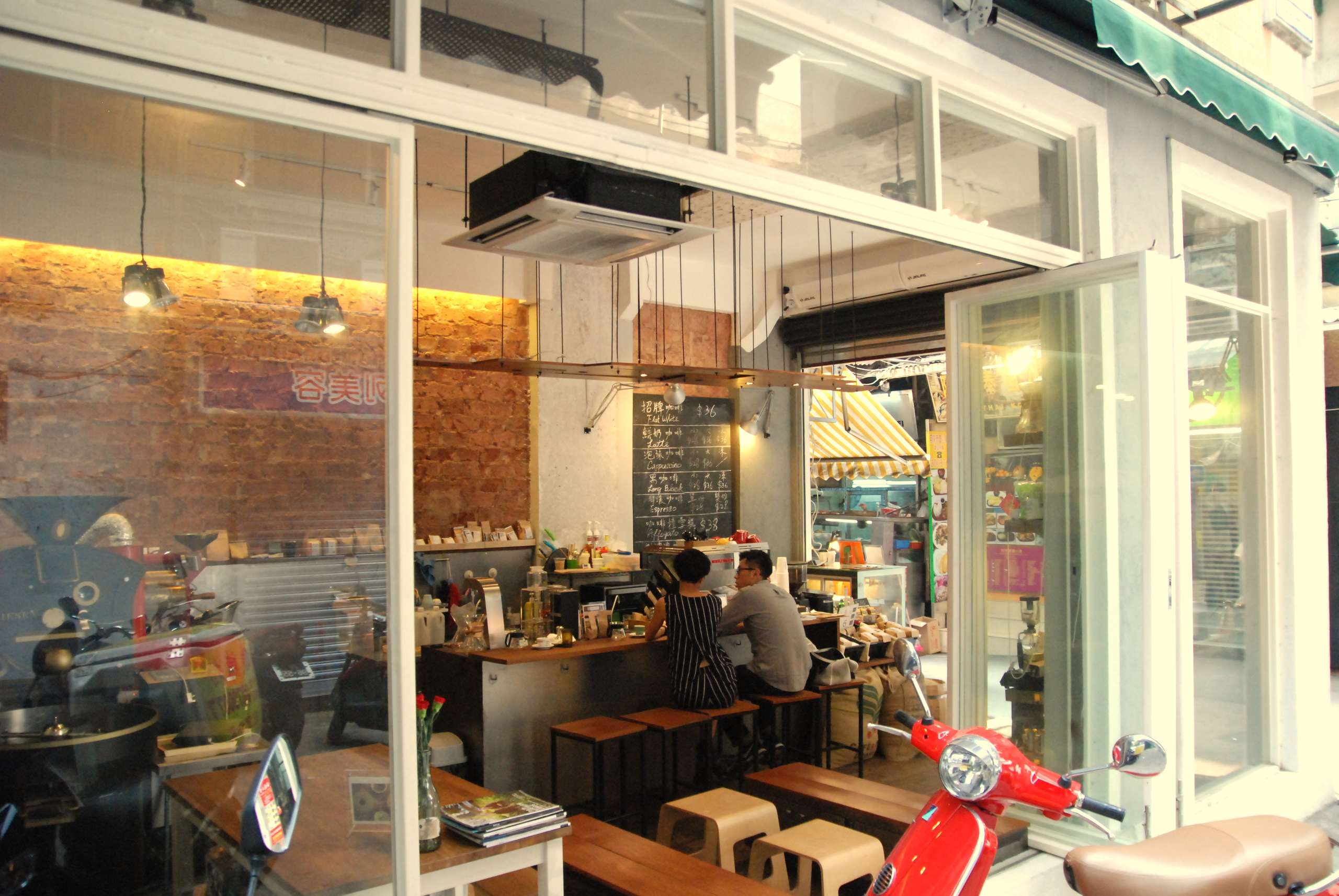 Couple having coffee in a cafe with glass walls 