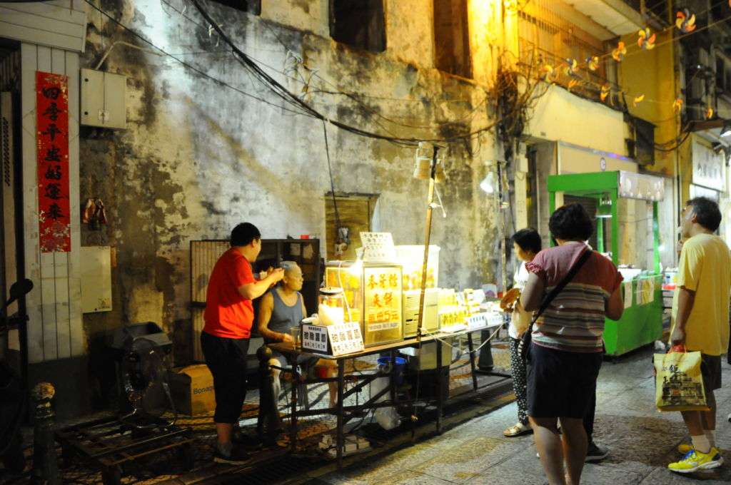 Customers gathered around a stall at the night market in Macau