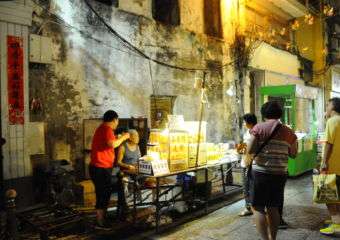 Customers gathered around a stall at the night market in Macau