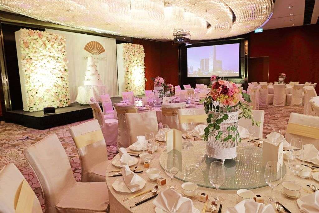 Light-colored wedding party table settings at Mandarin Oriental Macau.