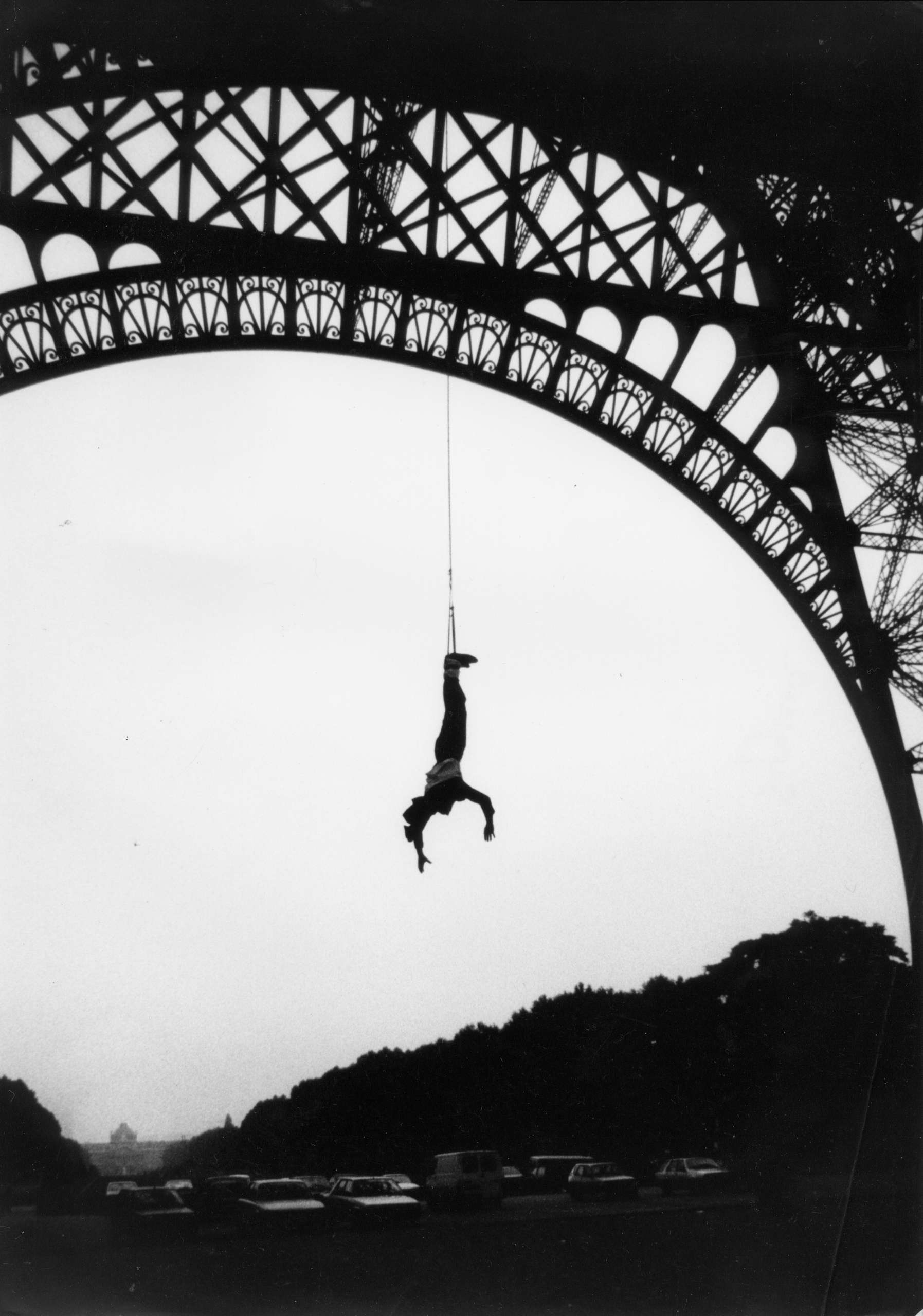 AJ Hackett handing upside down from the Eiffel Tower