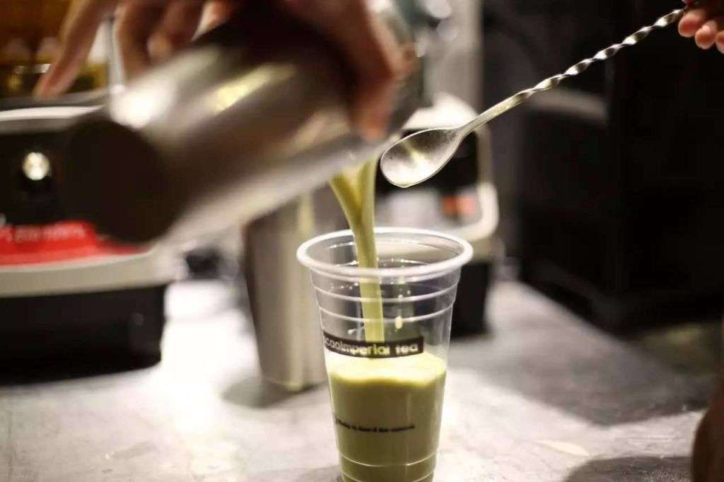 Matcha being poured into plastic cup