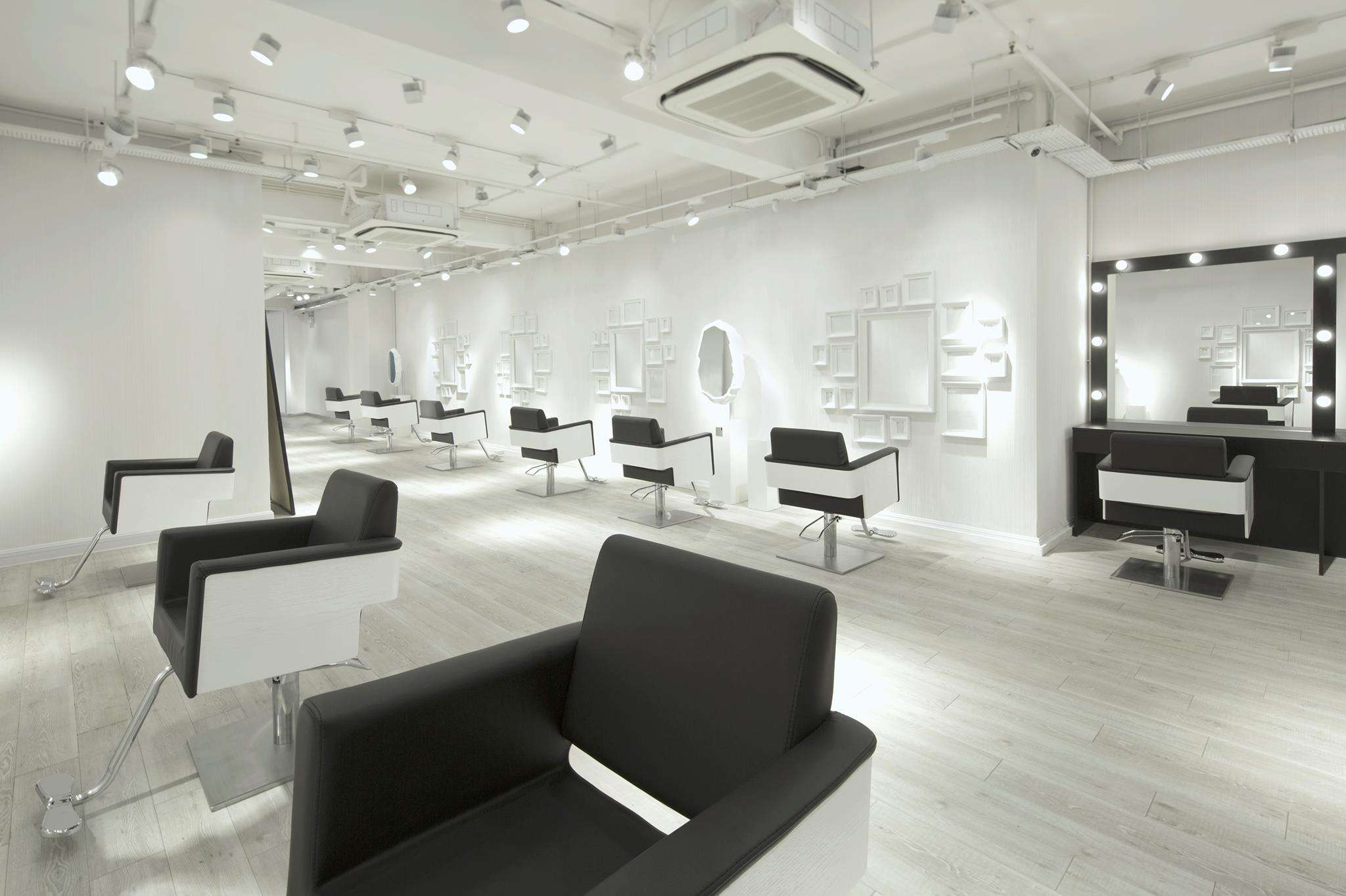 All white hair salon with black and white chairs