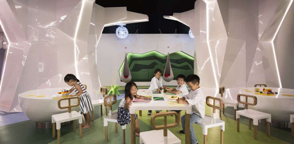 children sit at play tables at JW Marriots Kids Club in Macau
