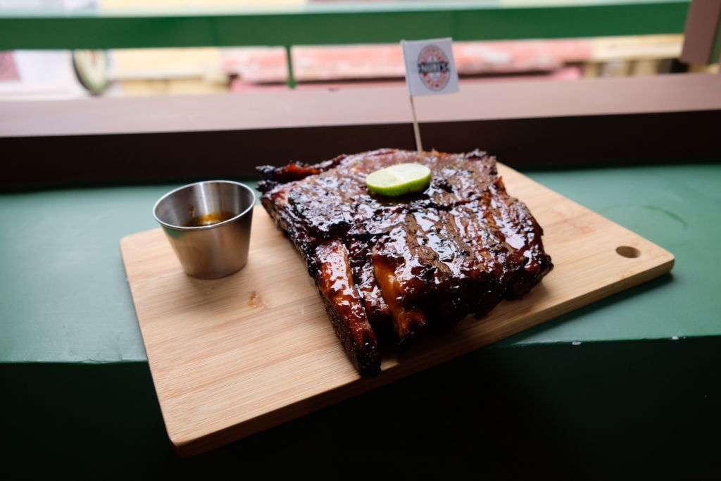 Ribs on a wooden platter at Naughty Nuri restaurant in Macau. 