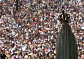 The statue of Our Lady of Fatima overlooks worshipers at the Fatima shrine