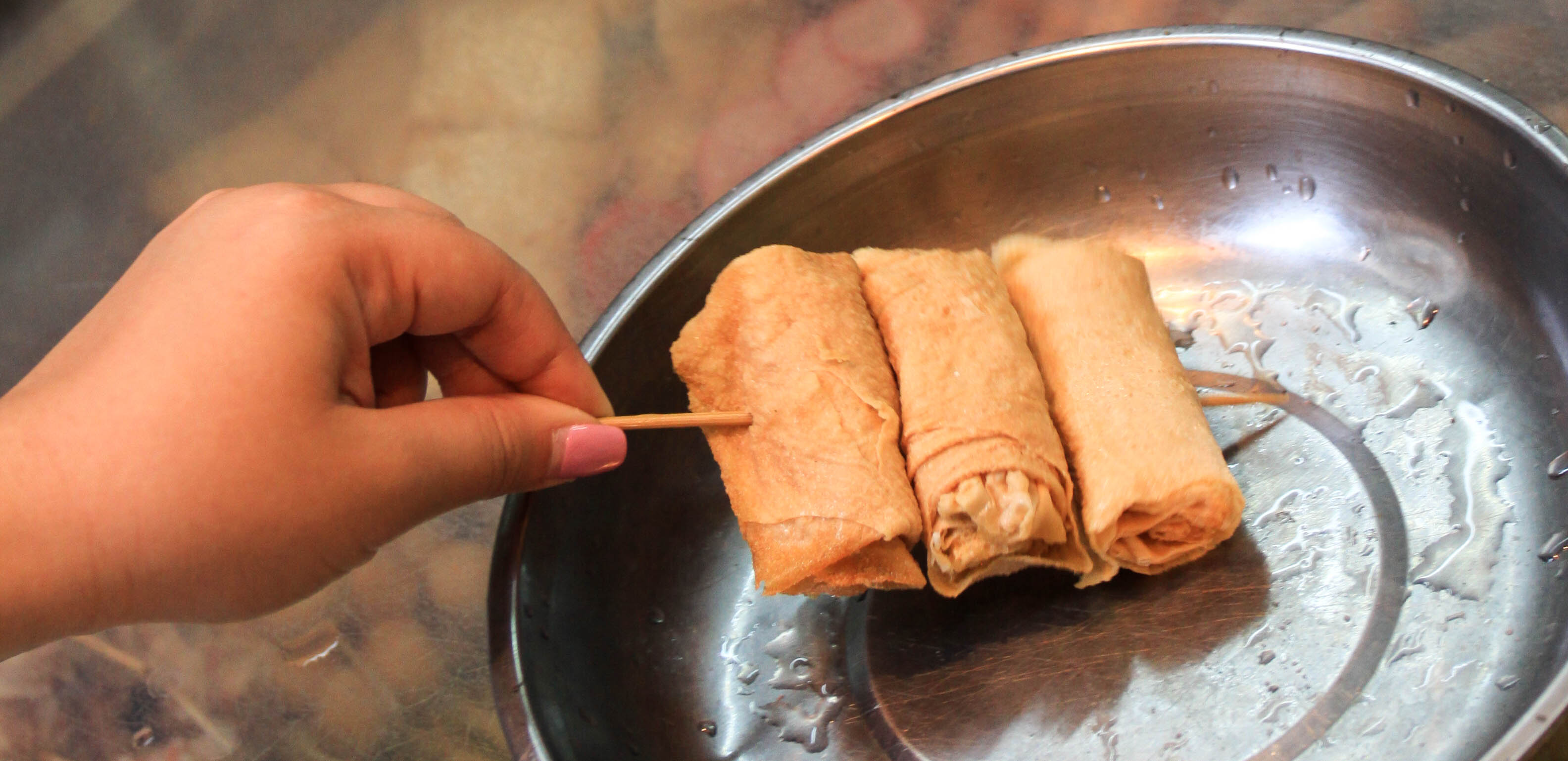 A skewer of fried bundled tofu skins.