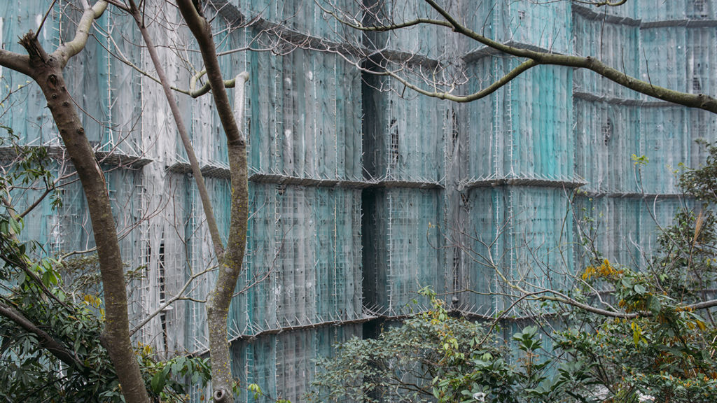 Construction netting covering building facade in photo by photographer Tang Kuok Hou in Macau.