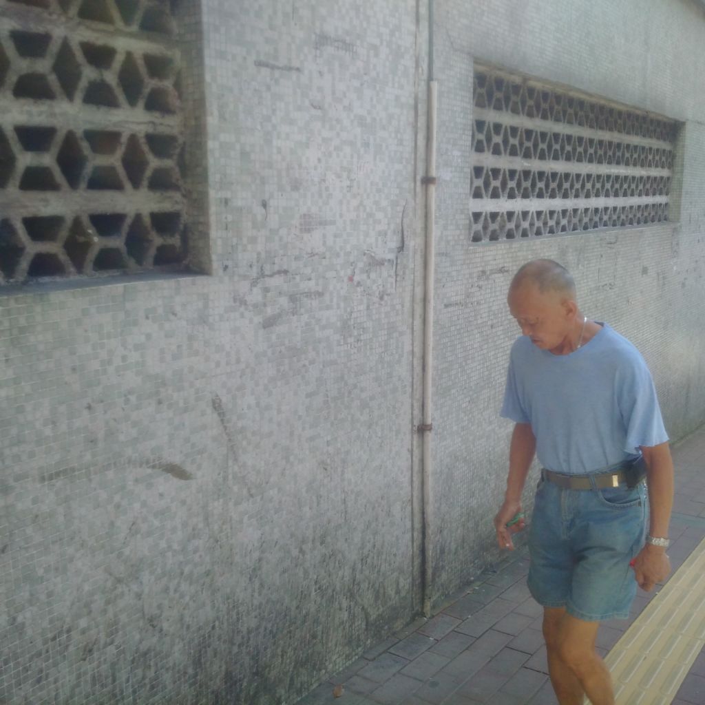 Man walking at the side street off Istmo de Ferreira do Amaral