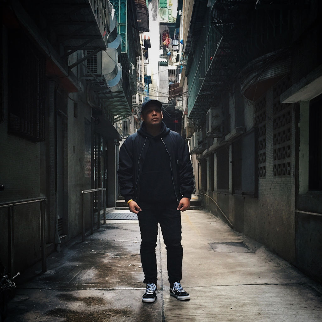 A young man posing in darker alleyway in Madai. 