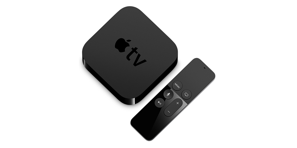 A black Apple TV box and remote control