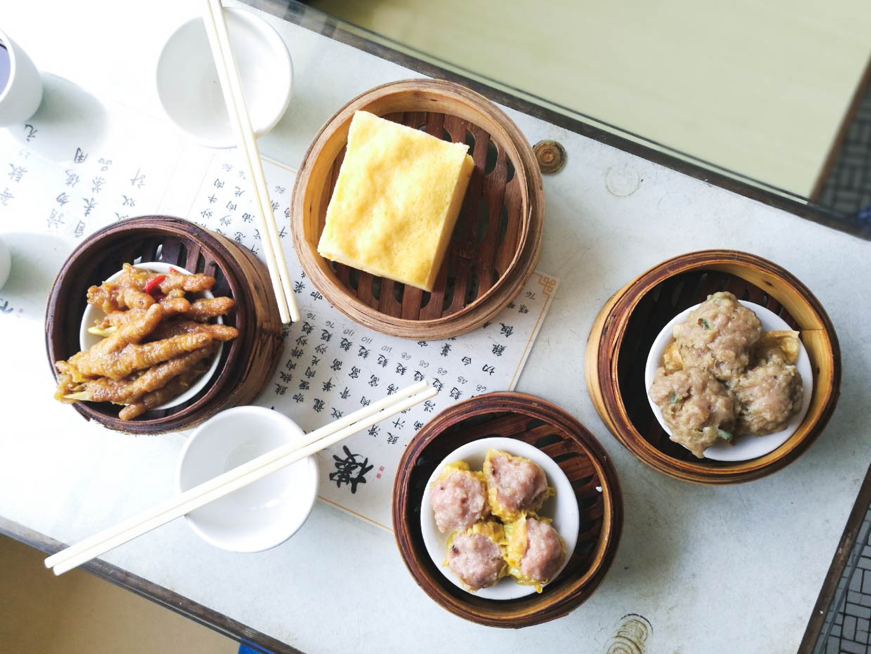 Four different dim sum baskets laid out on table in Long Wah teahouse in Macau.