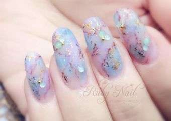 Hand with pastel light color glitter nails.