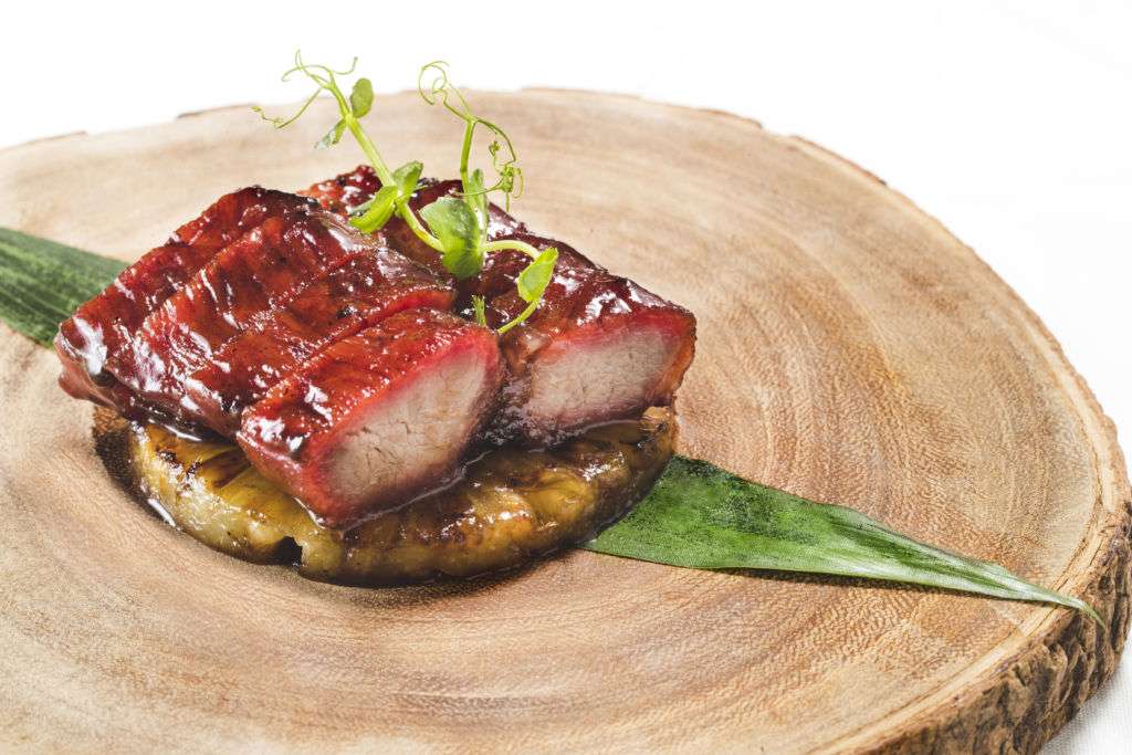 A dish of barbecued honey glazed Iberico pork with caramelized pineapple