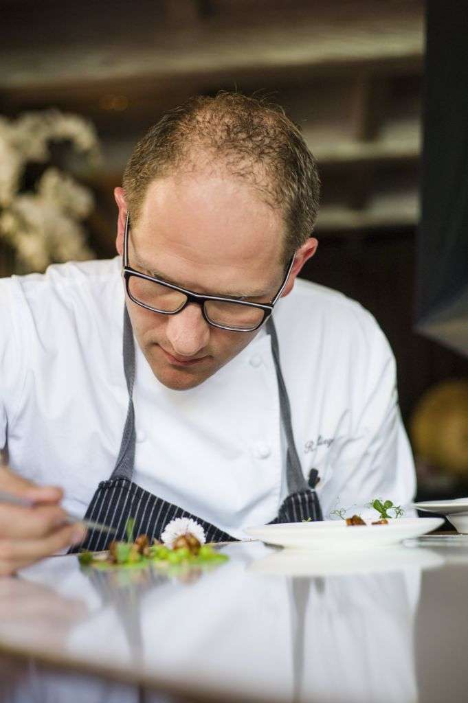 Chef Rolf Fliegauf plating a dish.