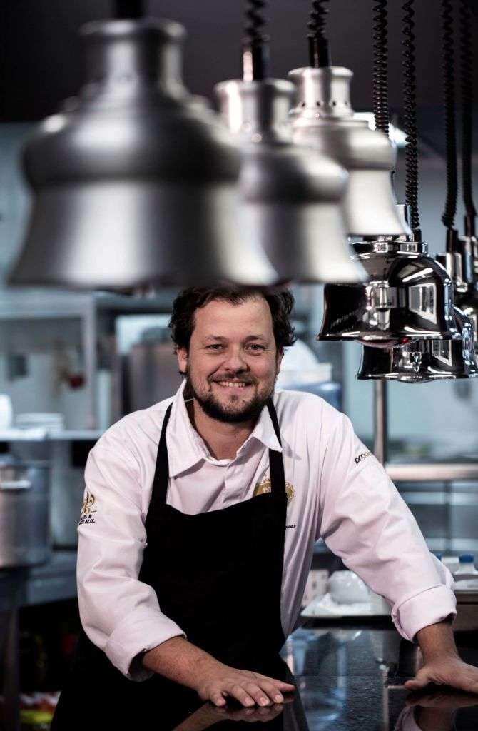 Chef João Rodrigues posing at kitchen counter.