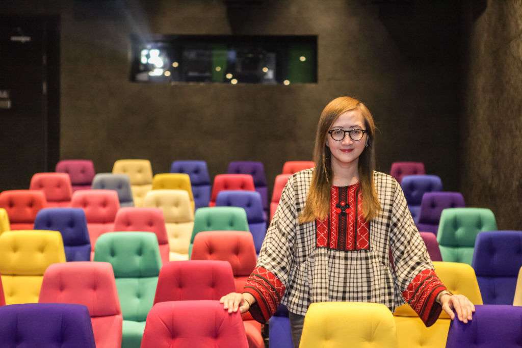 Cinematheque COO Rita Wong standing in their theater
