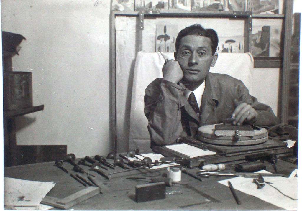 A man at a workbench with tools.