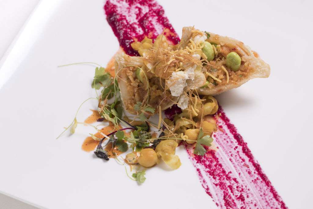 Song of India's head chef Manjunath Mural's samosa garbanzo goat cheese chat with tamarind mango spice drizzle.