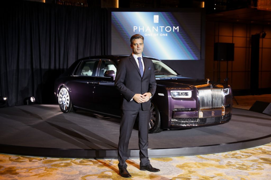 Rolls Royce Asia representative Ian Grant standing in front of a Rolls Royce automobile
