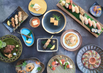 A table laid out with various sushi dishes