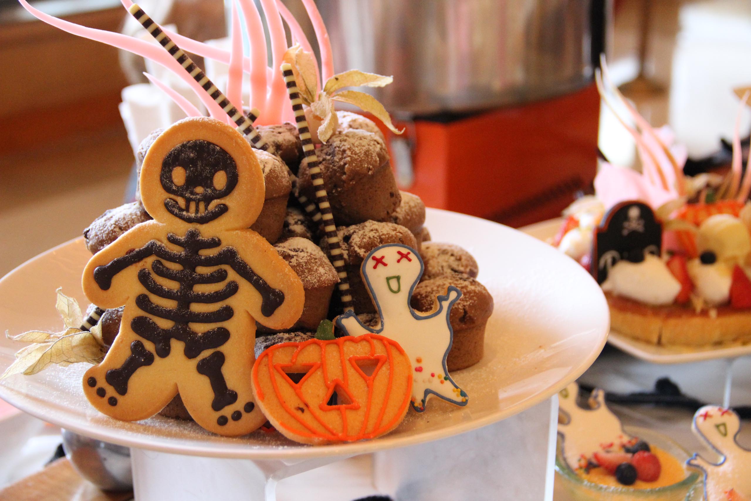 A plate of Halloween cookies and other desserts. 