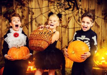 Three children in halloween costumes