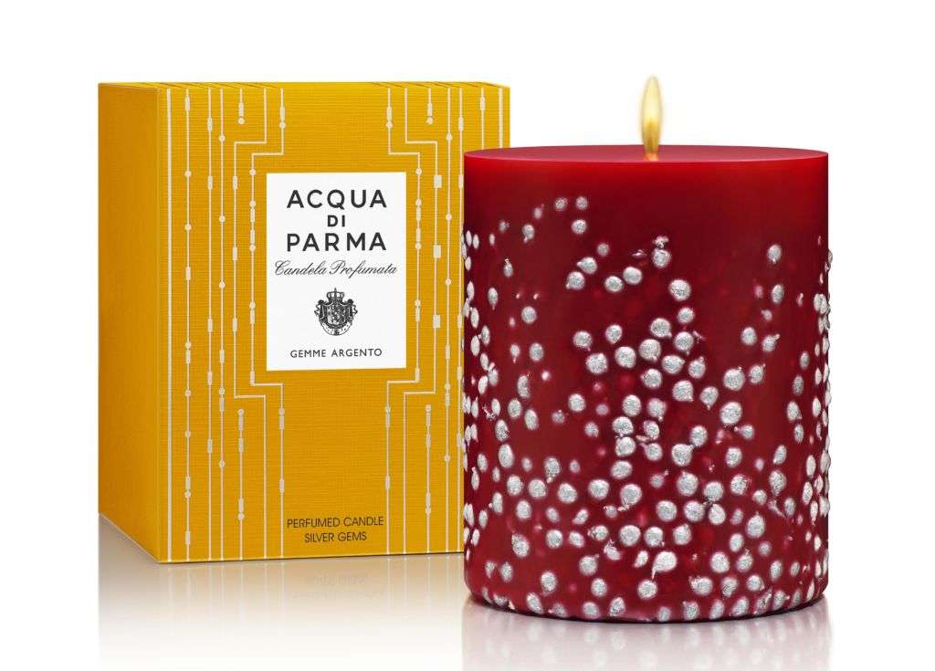 A red and white candle from Acqua di Parma with its yellow box in the close background