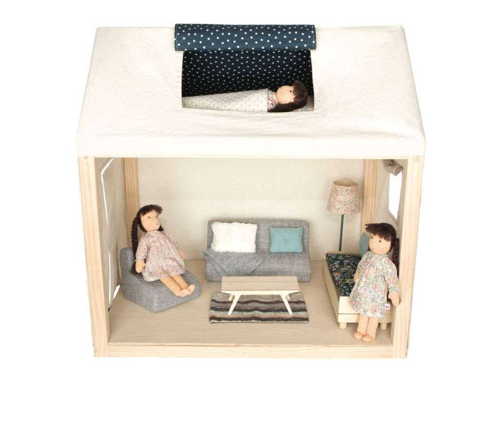 A dollhouse with two dolls inside.