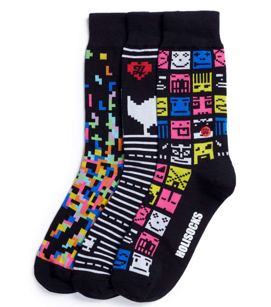 Three pairs of black socks with 8-bit computer game-style designs. 