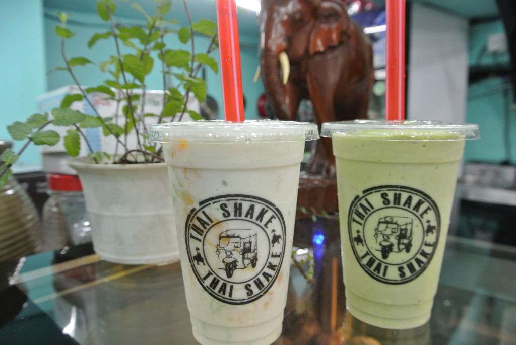 Two drinks in plastic cups from Thai Shake.