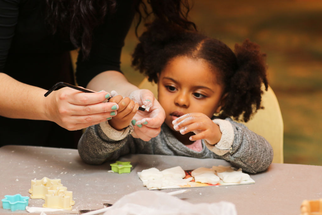 A girl making Christmas cookies. 