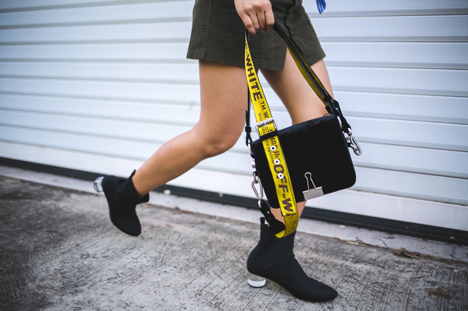 A model showing a black velvet bag. 