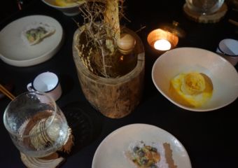 Small dishes illuminated by candlelight on a table.