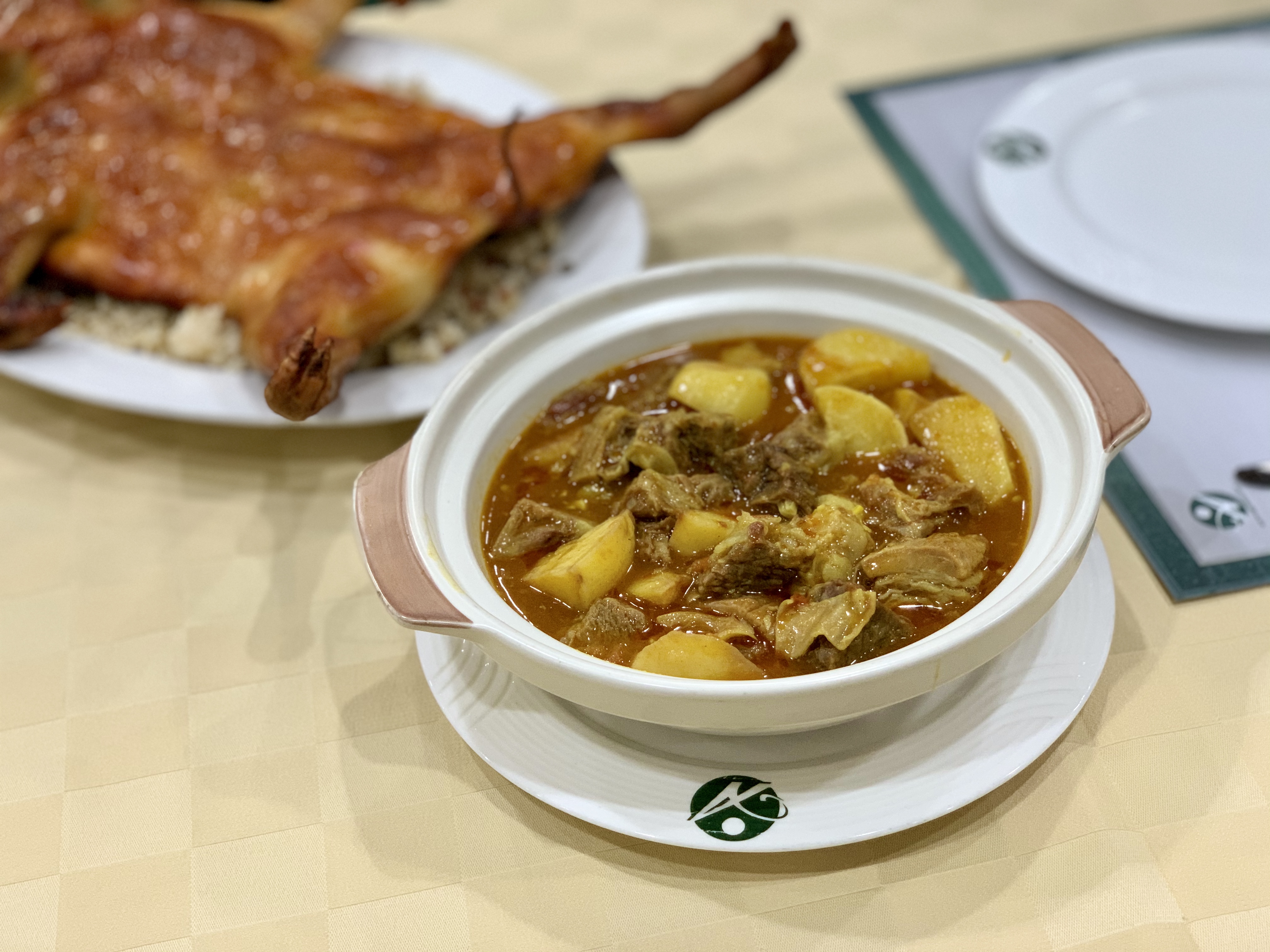 Ox curry and suckling pig in the background set in the table APOMAC Macau Lifestyle