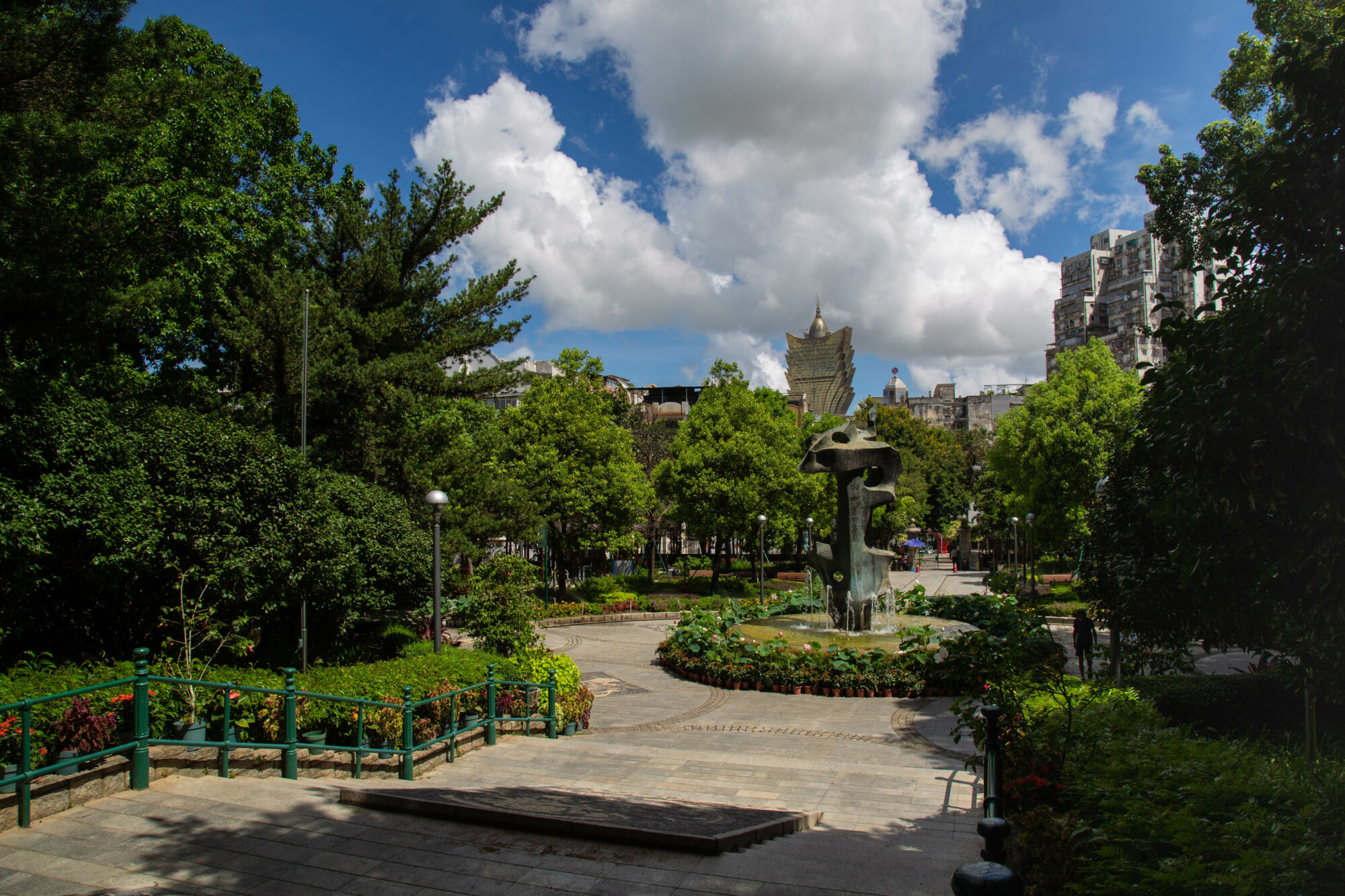 Wide shot showing the front garden and back of a statue at Camoes Garden