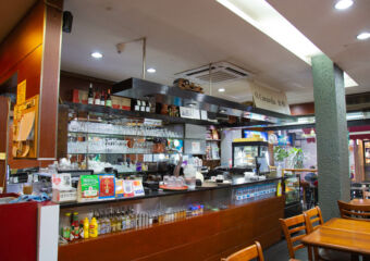 Wide shot of the bar and cashier counter at Caravela Pastelaria