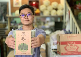 Cheong Kei Noodles Owner with Blurred Noodles in Hand Macau Lifestyle