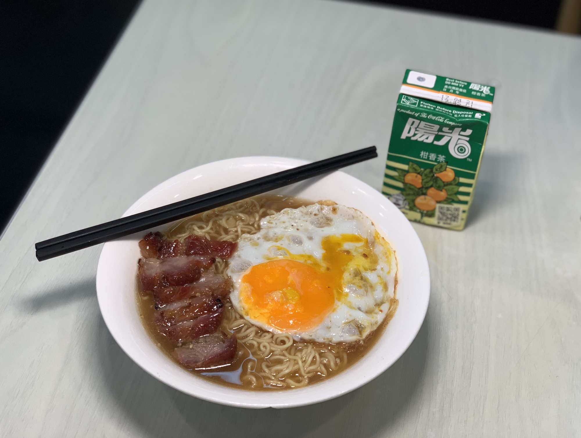 Instant Noodles with Char Siu from Meidu with Lemon Tea Pack on the Table from Above Macau Lifestyle