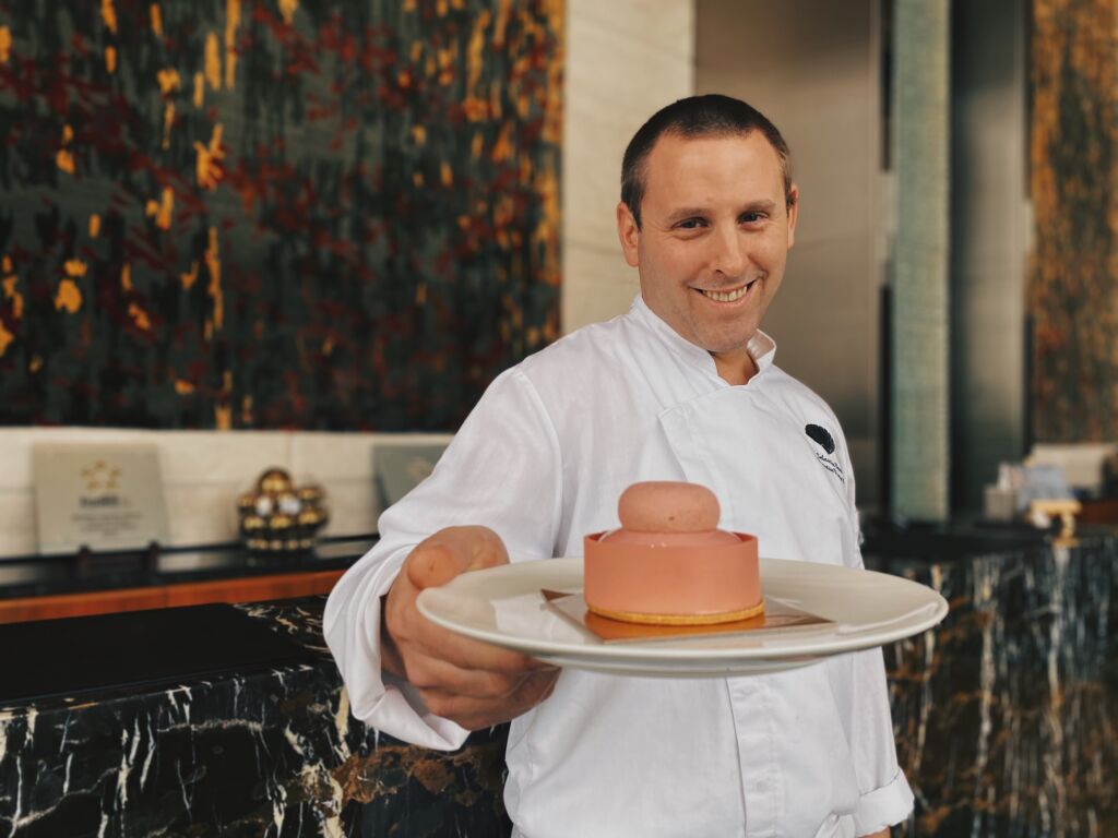 chef sebastien bernie holding pink bloom cake mandarin oriental macau