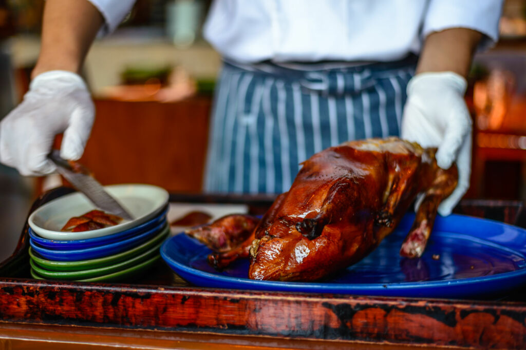 Chinese Chef chopping serving Peking duck