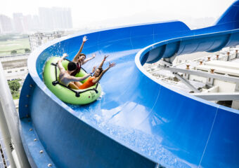 Studio City Water Park People Having Fun on a Blue Slide