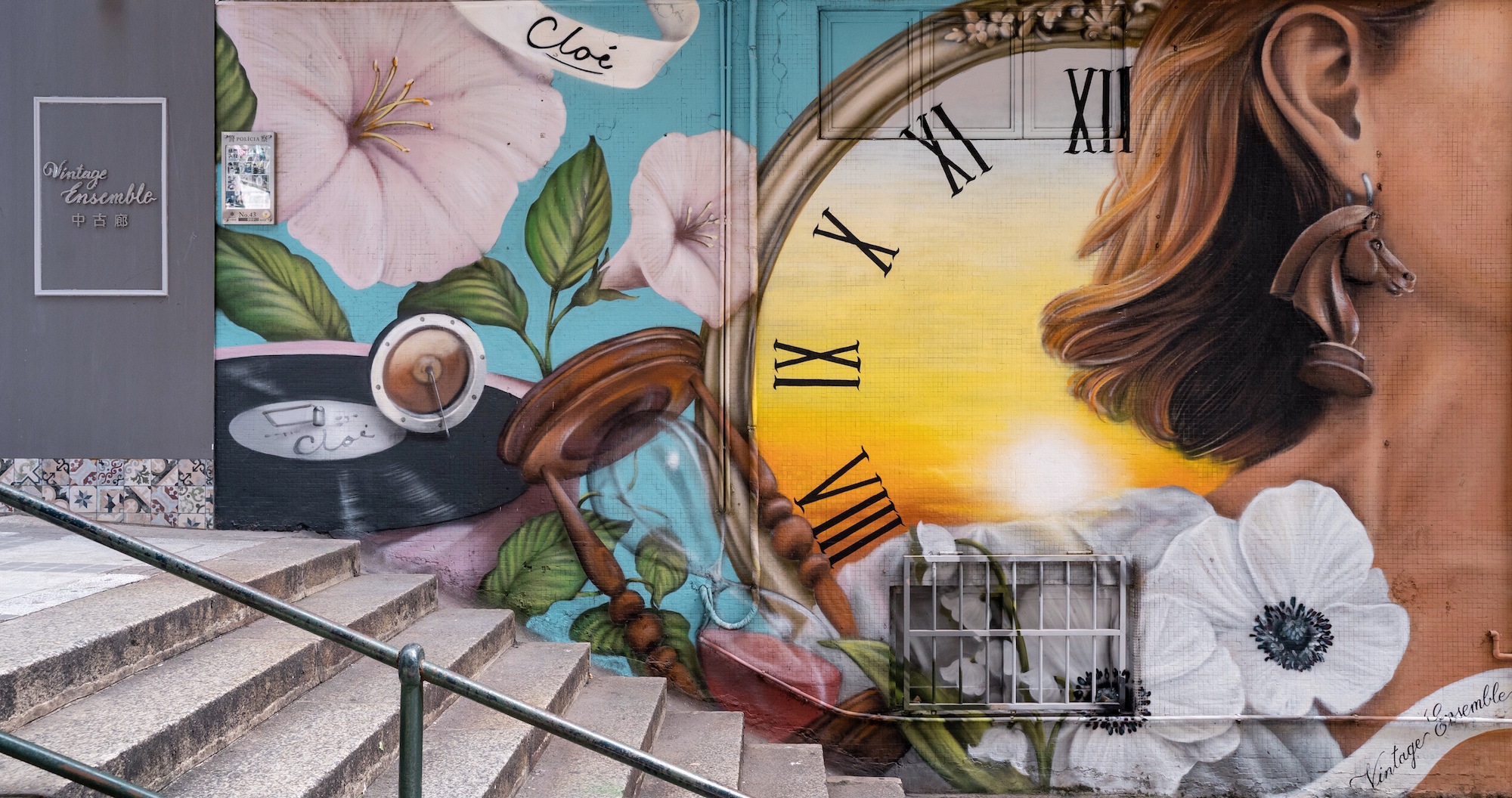 Vitorino Vong Wall Paint of a Clock and a Woman on Stairs Outside