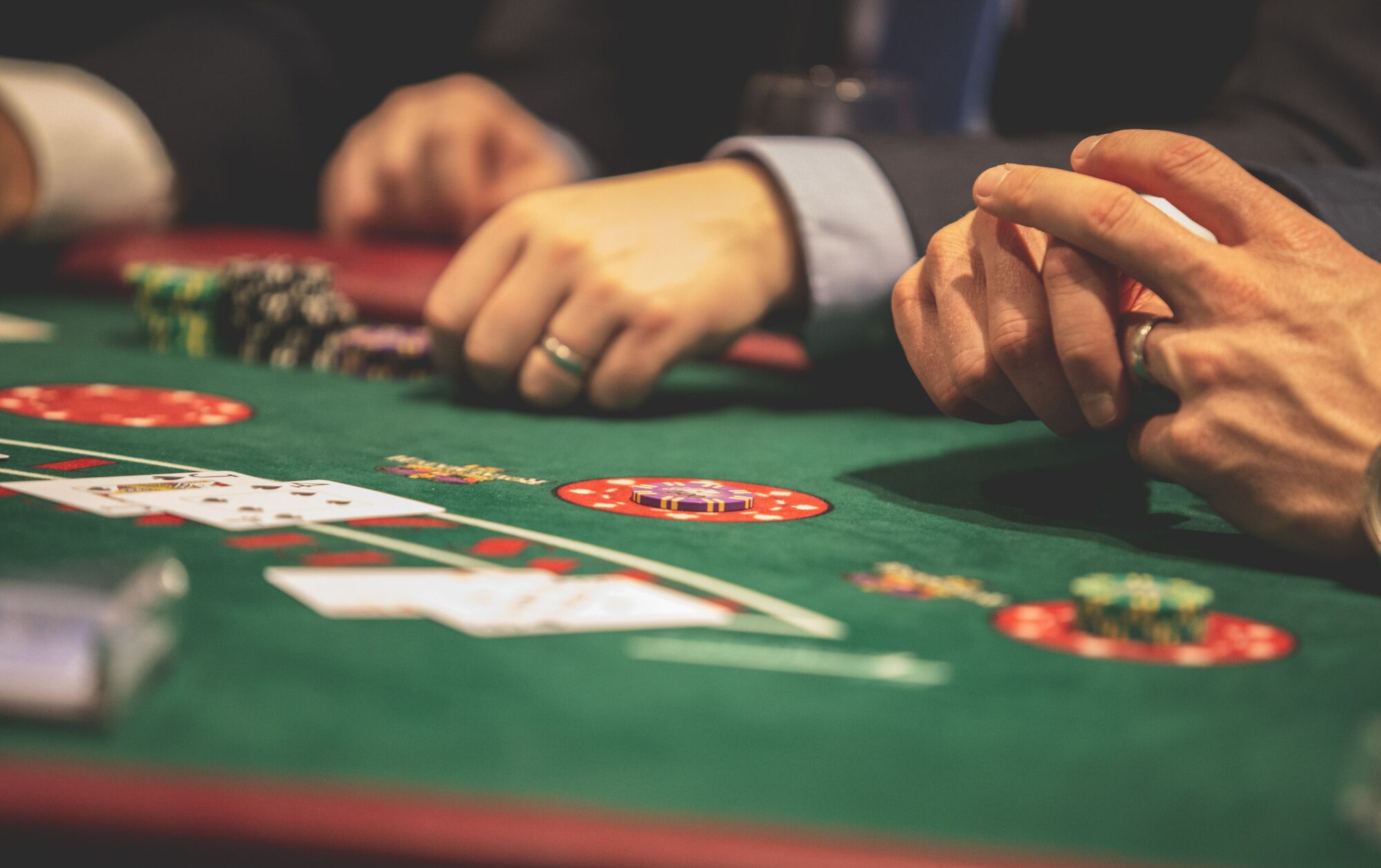 Hands of People Gambling Credits Pexels